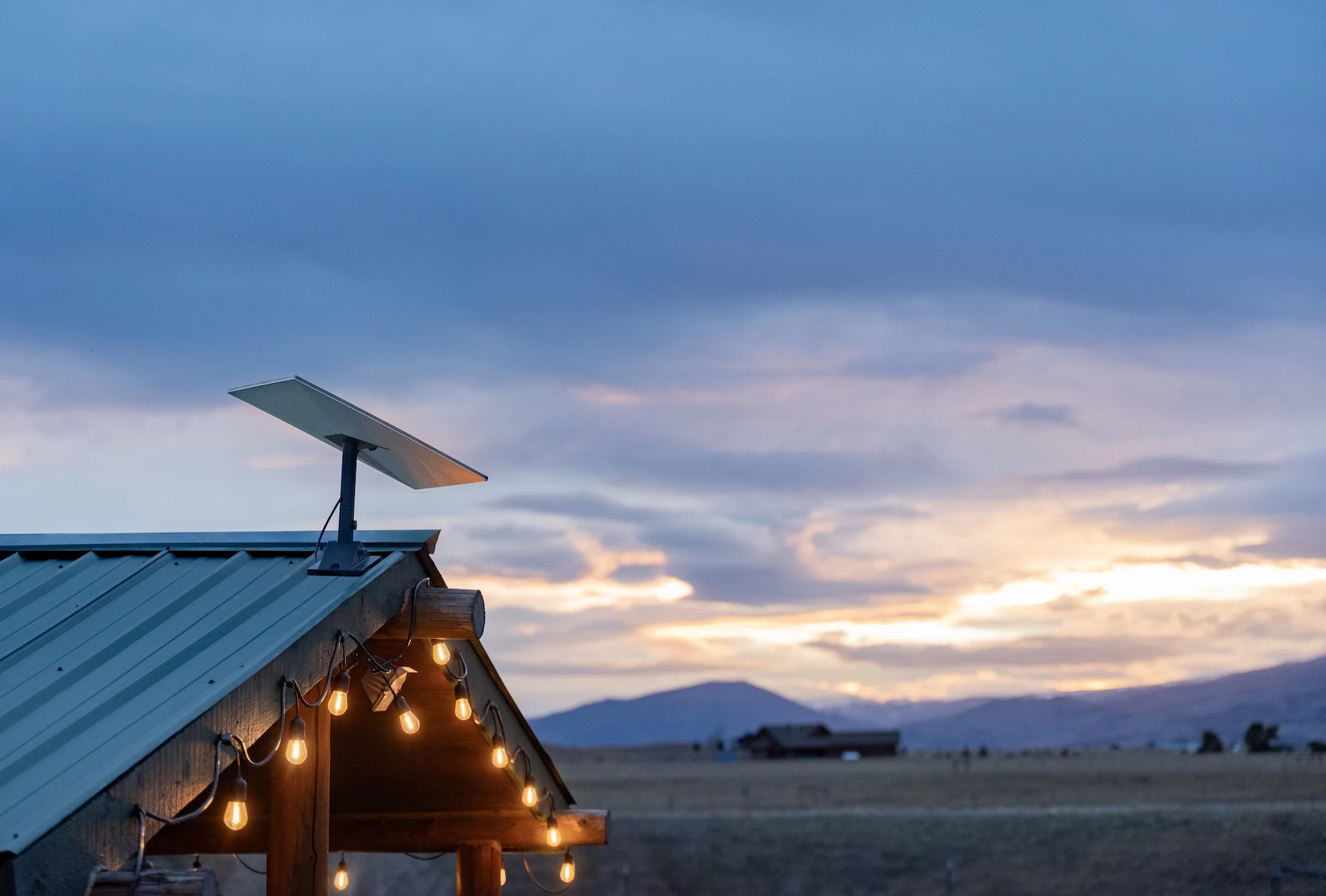 Starlink dish mounted on a rural Oregon barn roof at dusk