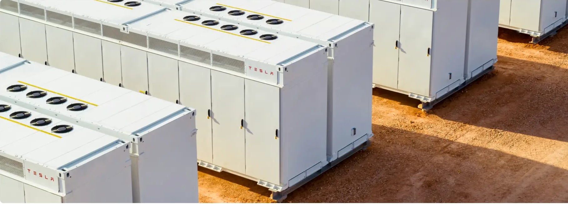 Rows of Tesla Megapack utility-scale battery storage units installed at a large energy project site